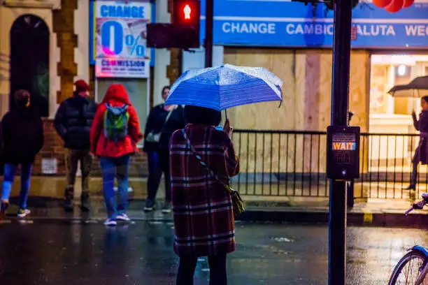 people-in-the-streets-of-london-with-umbrella-during-rain-in-the-picture-id932326600.jpg